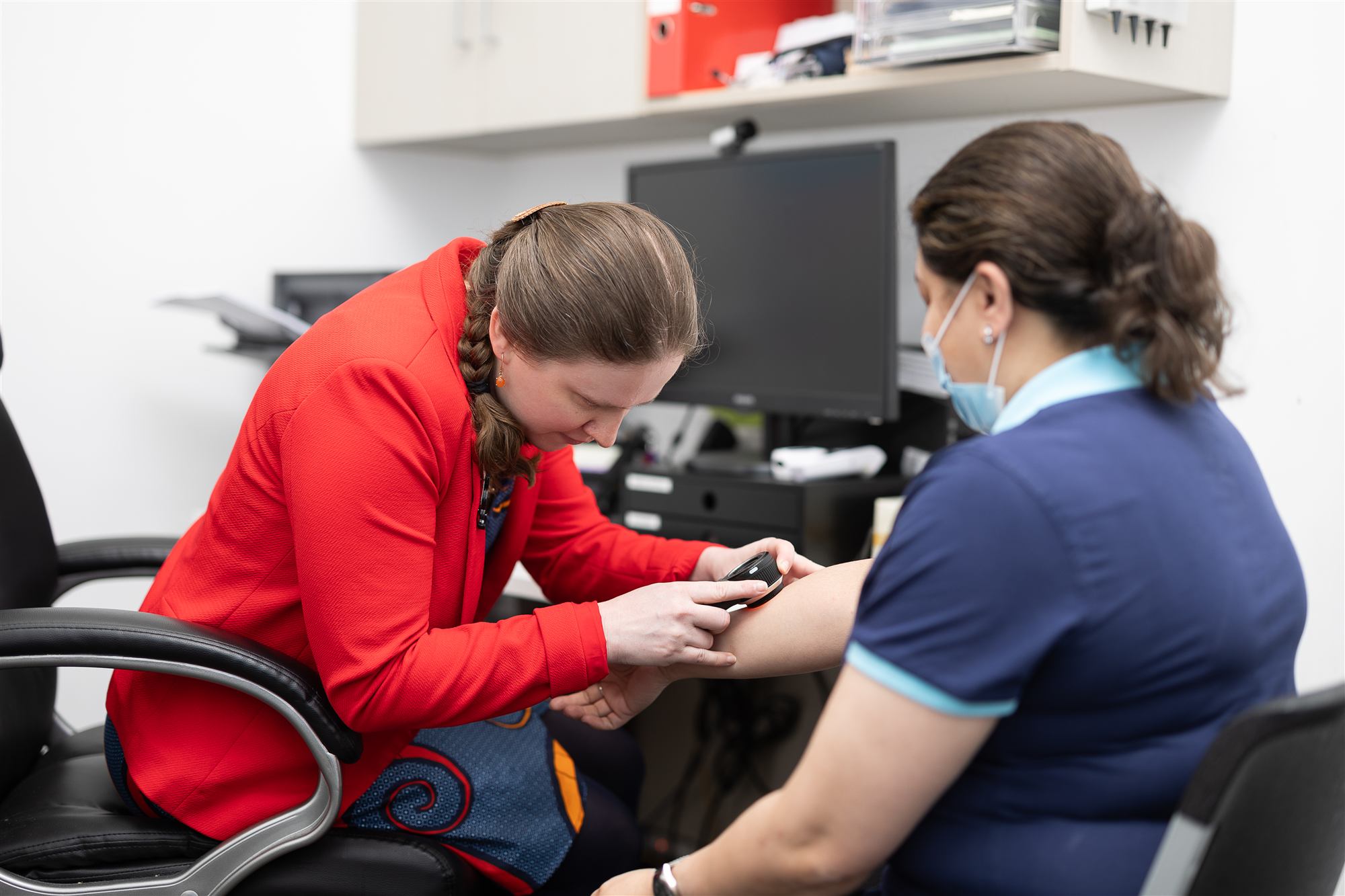 A practice nurse looking after a patient