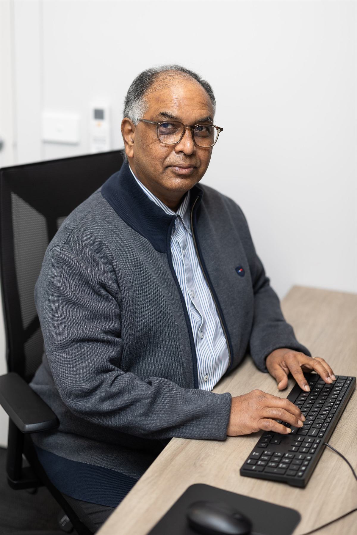 One of our GPs at his desk, ready for a consultation