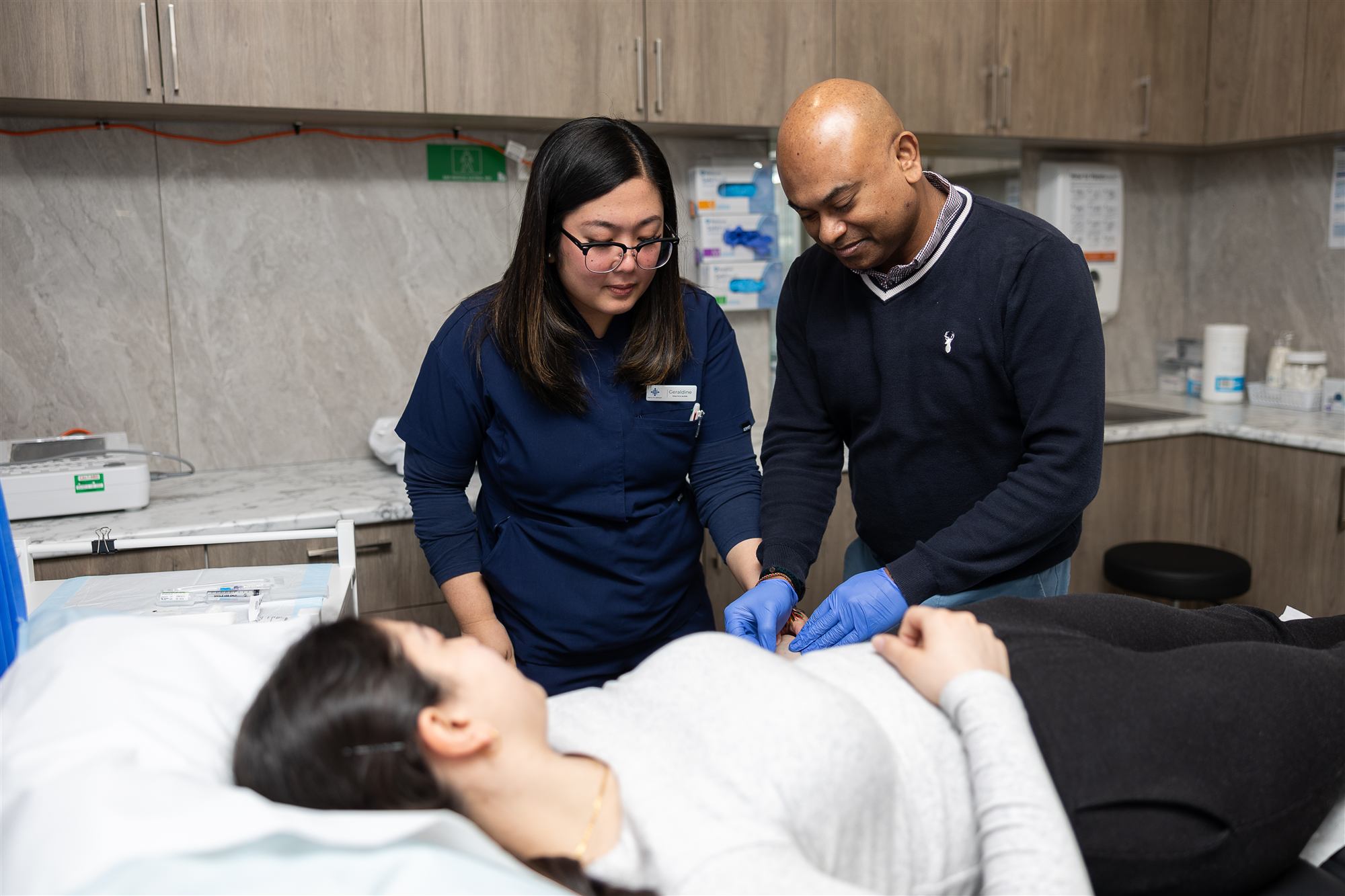 Practice nurse Geraldine and a GP caring for a patient in the treatment room